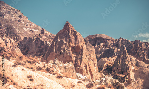 Landscape with houses in Cappadocia mountains under blue sky  Turkey
