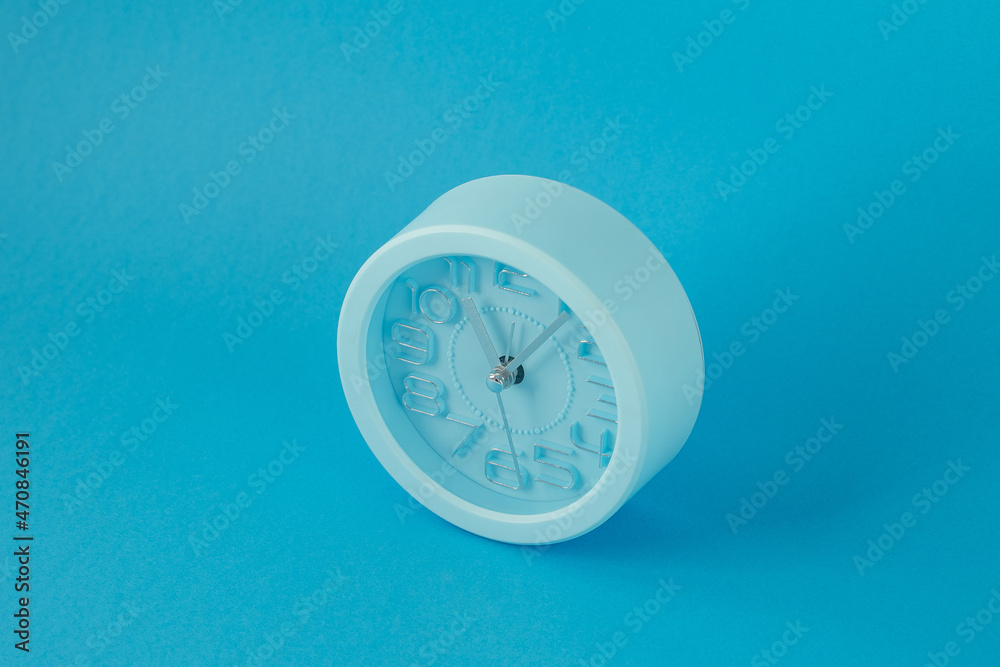 table clock isolated on blue background, horizontal image, top view table clock isolated on blue background, horizontal image, top view