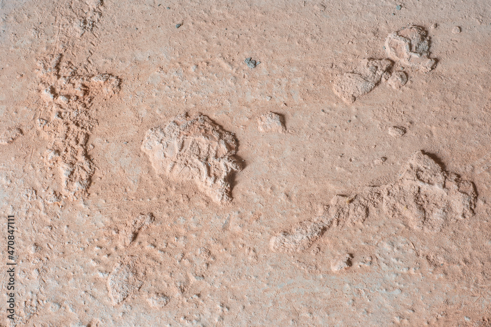 Concrete surface with large irregularities covered with red dust Concrete surface with large irregularities covered with red dust