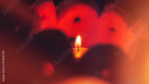 Romantic background in soft focus. A small candle burns in a pumpkin-carved candlestick.