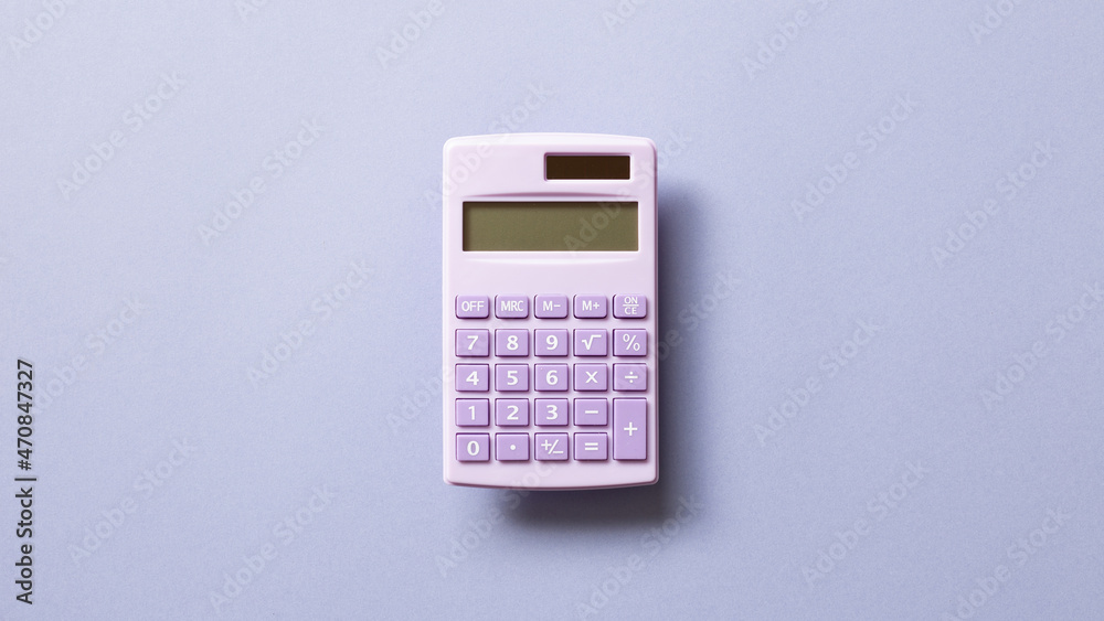Purple digital calculator isolated on purple background. top view, copy space