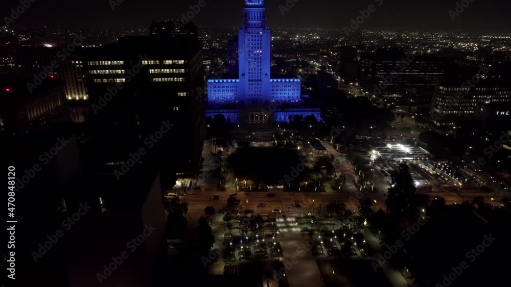 Los Angeles city hall illuminated blue to thank healthcare workers aerial rising view above cityscape landmark at night Los Angeles city hall illuminated blue to thank healthcare workers aerial rising view above cityscape landmark at night