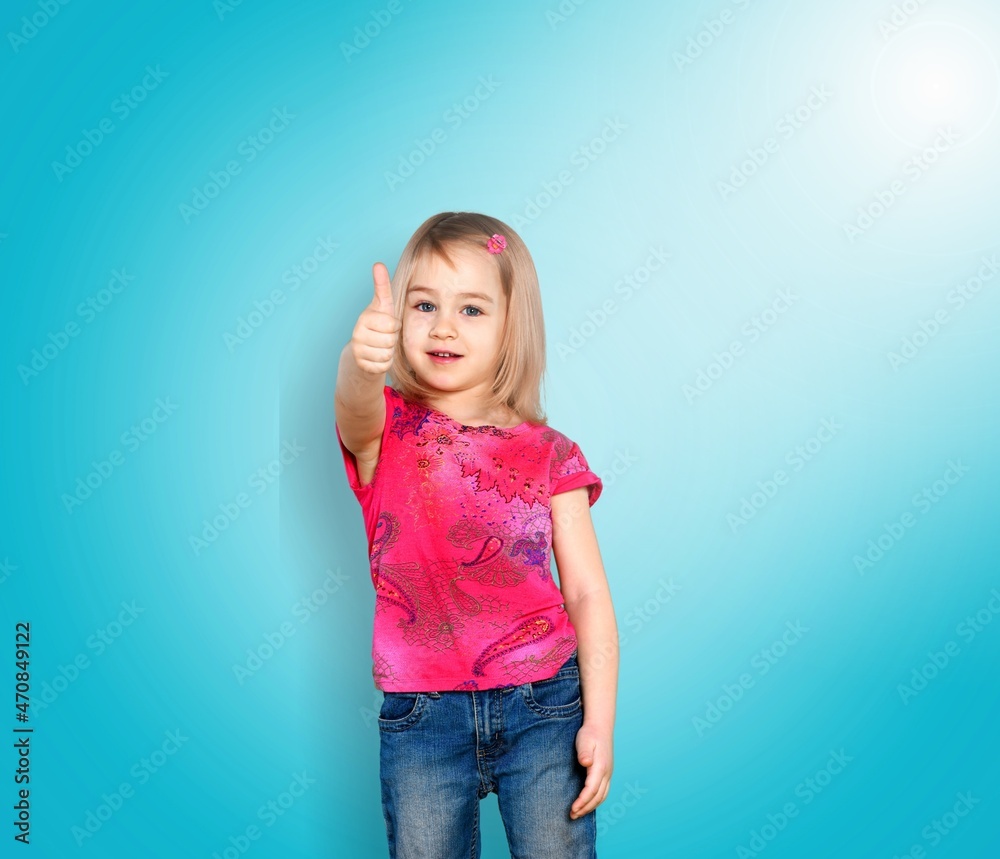 Happy child shows thumbs up gesture with both hands Happy child shows thumbs up gesture with both hands