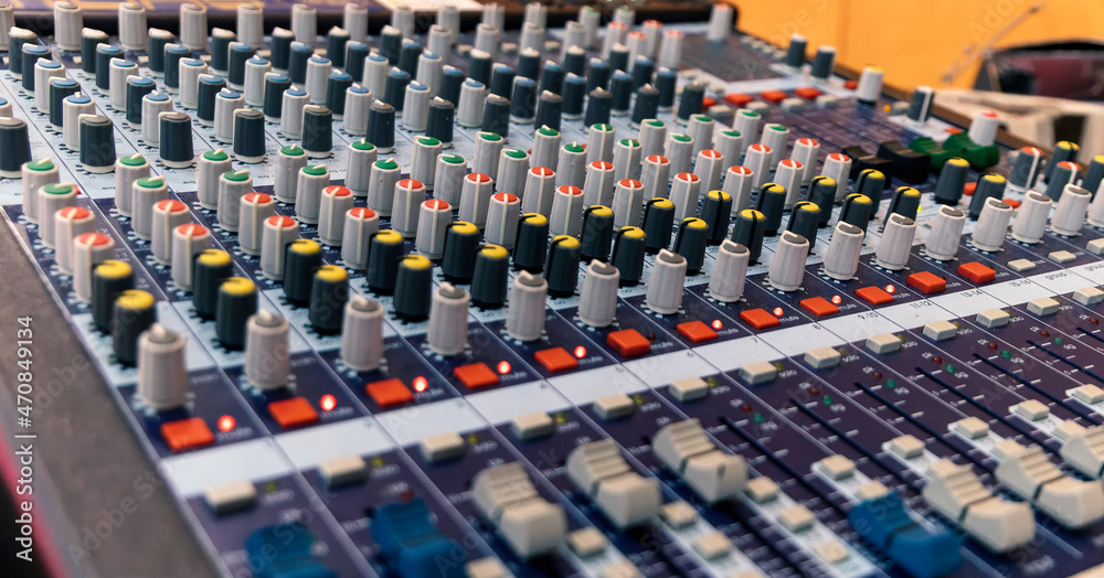 Controls of audio mixing console. Close up. Selective focus