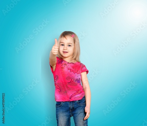 Happy child shows thumbs up gesture with both hands