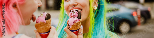 Young white women smiling while eating ice cream together
