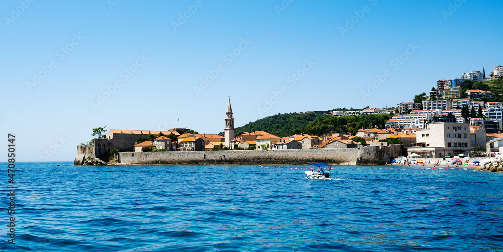 Montenegro city view with old buildings from Adriatic sea. Ancient Mediterranean architecture with mountains and beautiful nature