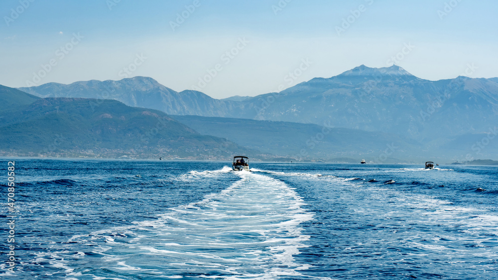 Foam trace in Adriatic sea after boat in Montenegro. Beautiful bay view with mountains landscapes Foam trace in Adriatic sea after boat in Montenegro. Beautiful bay view with mountains landscapes