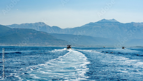 Foam trace in Adriatic sea after boat in Montenegro. Beautiful bay view with mountains landscapes