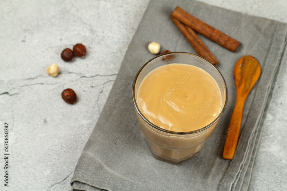 Caramel chocolate pudding on a gray table with chocolate and nuts. Caramel chocolate pudding on a gray table with chocolate and nuts.