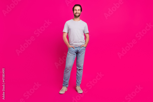 Full body photo of young handsome guy arms in pocket wear casual clothes isolated over magenta color background