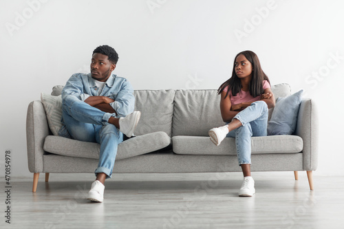 Young black couple having fight, ignoring each other