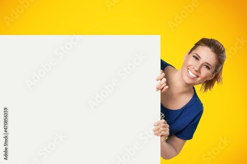 Intresting Offer. Happy Casual Woman Peeping Out The Side Of White Advertisement Board
