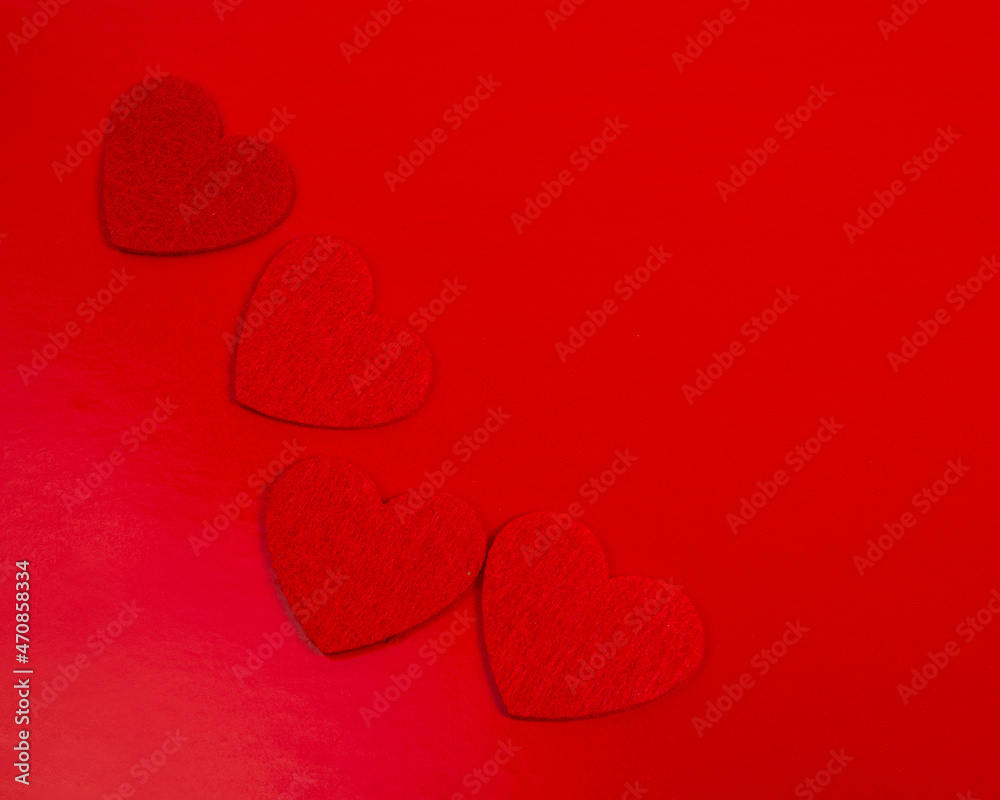Obraz premium Red felt hearts love decor on the red background