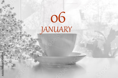 calendar date on light background with porcelain white tea pair and white gypsophila with copy space. January 6 is the sixth day of the month