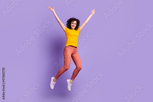 Full body photo of young cheerful girl have fun jump up excited casual outfit isolated over violet color background