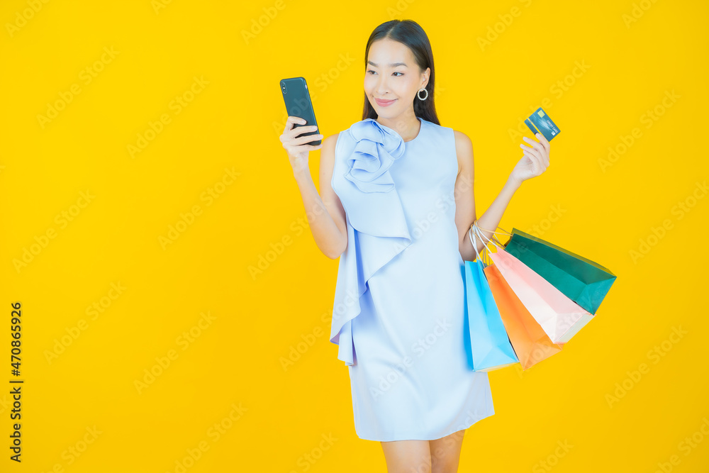 Portrait beautiful young asian woman smile with shopping bag