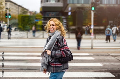 Young woman on a crosswalk in Warsaw, Poland  © pikselstock