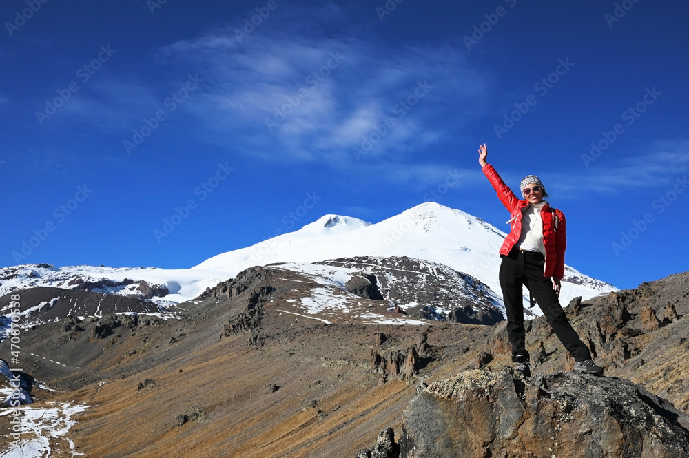 Hiker Young Woman on The Mountain Top Against blue sky