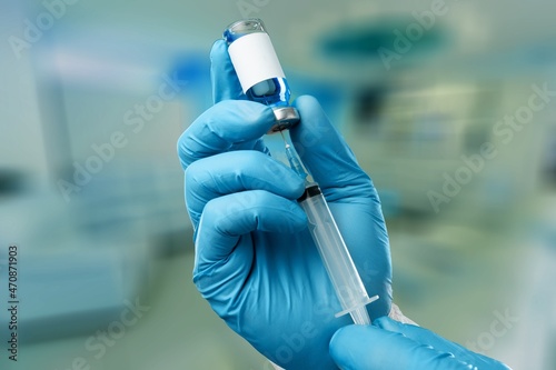 Doctors hand holding syringe and bottle for vaccination.Vaccine for protection Covid-19