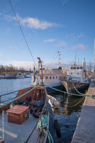 Photography Old sailing, fishing and cargo boats at the pier Strandvägen in the bay Ladugård