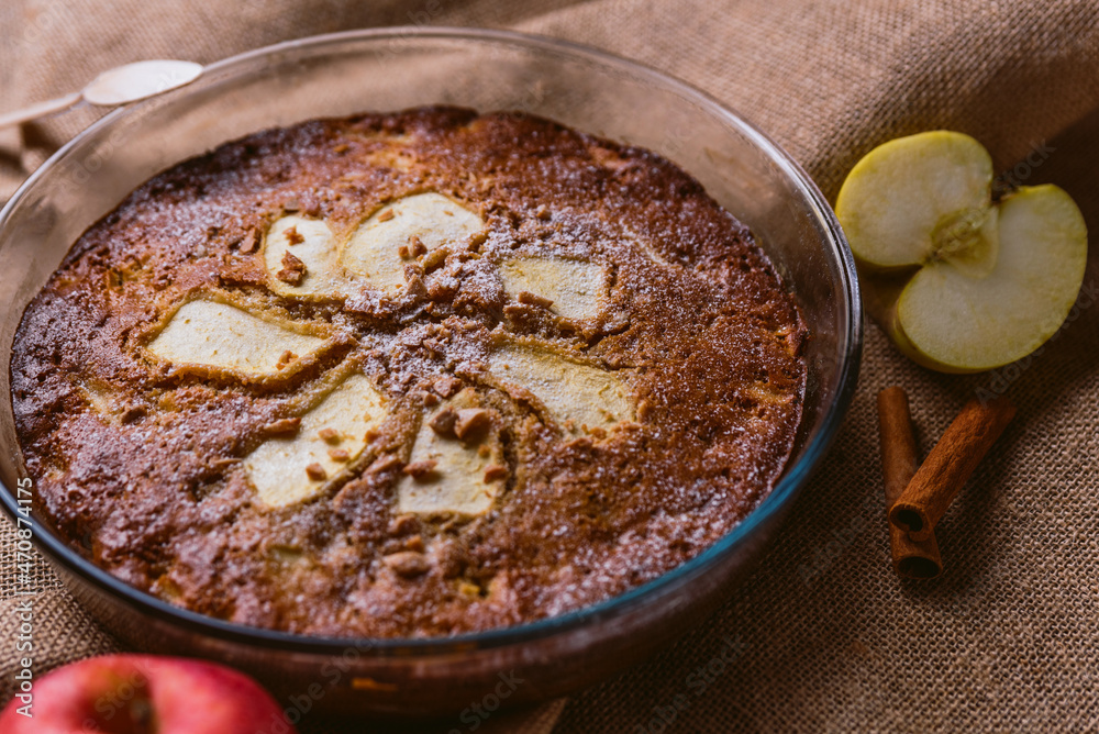 close up of a fresh homemade apple pie on rustic brown burlap fabric with soft natural light, with apples and cinnamon sticks, freshly oven and appetizing, with dry fruits on top and apple slices close up of a fresh homemade apple pie on rustic brown burlap fabric with soft natural light, with apples and cinnamon sticks, freshly oven and appetizing, with dry fruits on top and apple slices