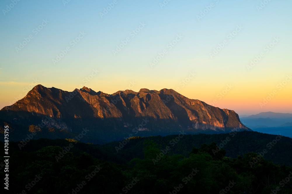Rock mountains with sunlight at sunset.