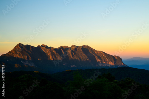 Rock mountains with sunlight at sunset.