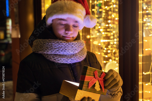 Boy in Santas hat with gift...