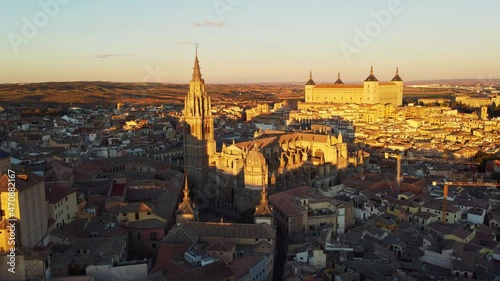 Dramatic aerial drone footage of the sunset over the Tolede, or Toledo, medieval old town with the cathedral and the Alcazar in the background near Madrid in Spain photo