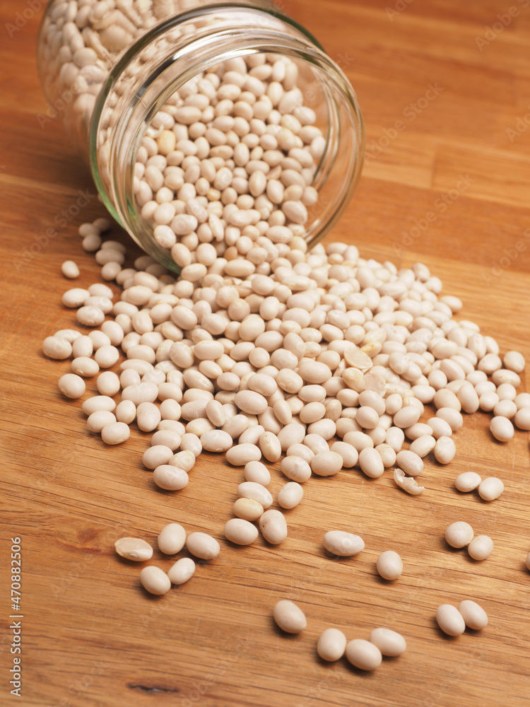 Organic white beans in a canning jar on a kitchen table Organic white beans in a canning jar on a kitchen table