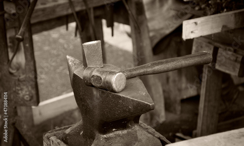 Blacksmith workshop at medieval fair in Provins, France. Tools. Sepia historic photo.