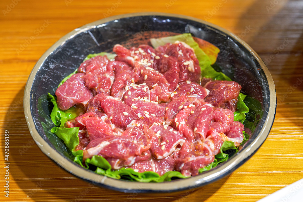 Closeup of a dish of marinated pork belly beef barbecue ingredients