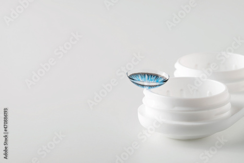 Colored contact lenses. Macro, gray background. Eye color change. Copy Space