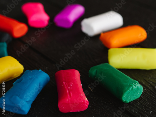 Set of multicolored plasticine placed on table