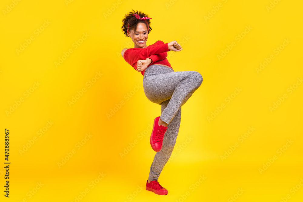 Photo of cheerful pretty lady dance have fun wear pin-up outfit shiny pants isolated yellow color background Photo of cheerful pretty lady dance have fun wear pin-up outfit shiny pants isolated yellow color background