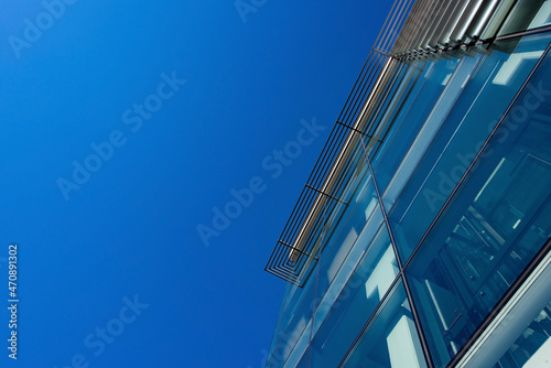 Modern glass architecture of office building against the sky from below 