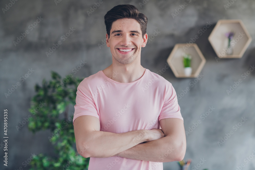 Fototapeta premium Photo of handsome self-assured positive guy crossed hands wear casual outfit in comfortable apartment home indoors