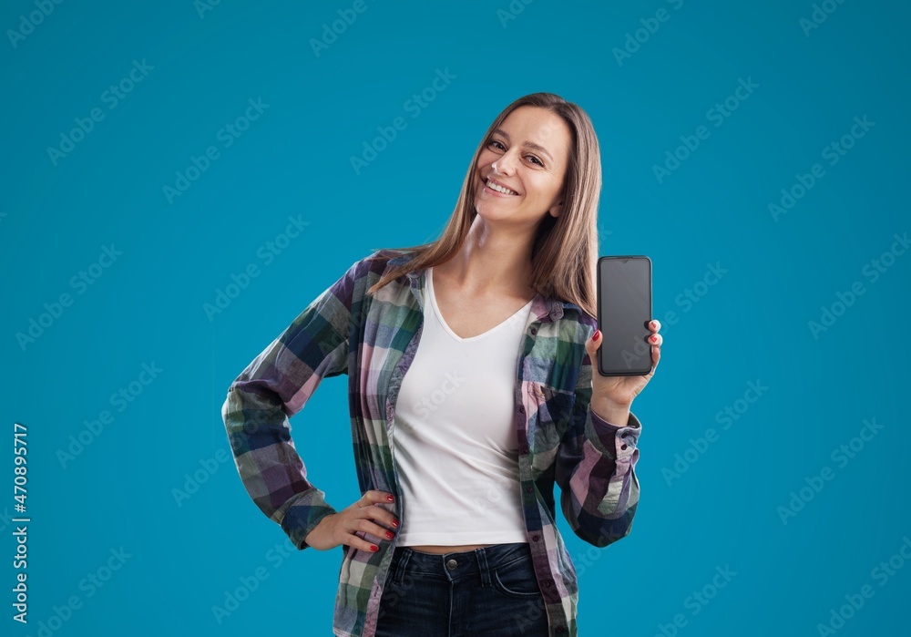Young lady show smartphone screen with positive expression, smiles broadly Young lady show smartphone screen with positive expression, smiles broadly