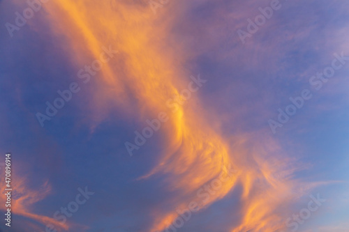 Abstract nature background. Dramatic blue sky with orange colorful sunset clouds in twilight time