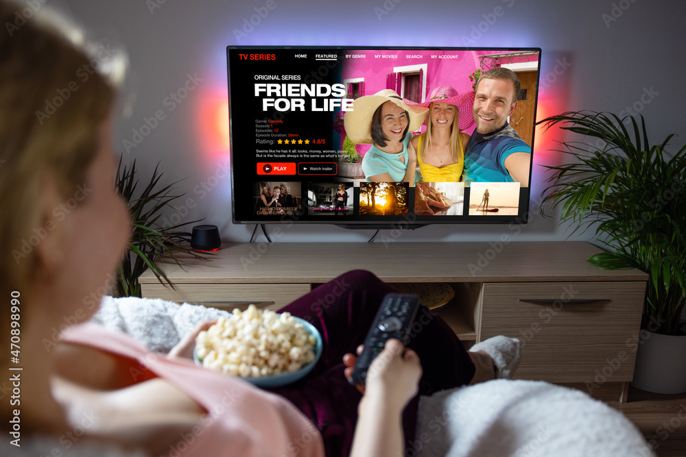 Woman watching TV series and movies on online streaming service at home - obrazy, fototapety, plakaty 