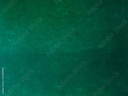 Dark green old velvet fabric texture used as background. Empty green fabric background of soft and smooth textile material. There is space for text..