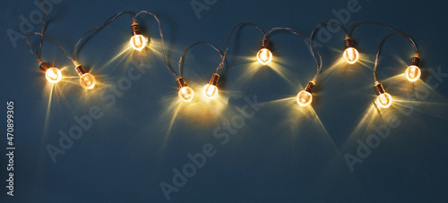 christmas electric garland on blue paper background