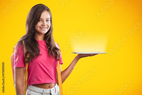 Smiling cute smart female shows fingers to empty space 