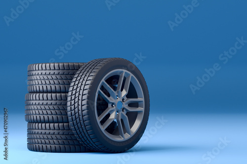 four tires with rims placed on a blue background
