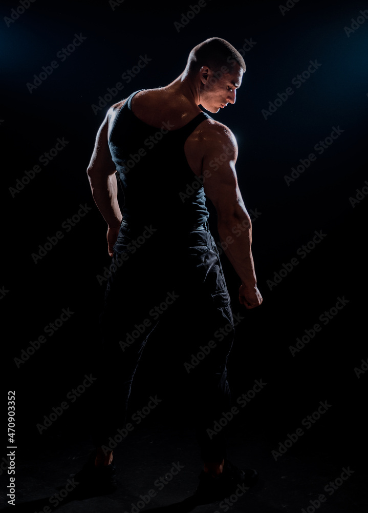 Bodybuilder showing his back and biceps muscles Bodybuilder showing his back and biceps muscles