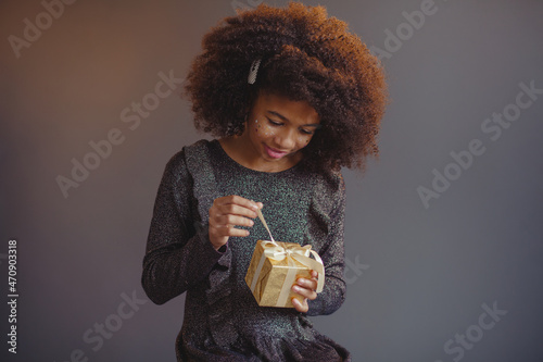 Lovely festive girl open a gift box