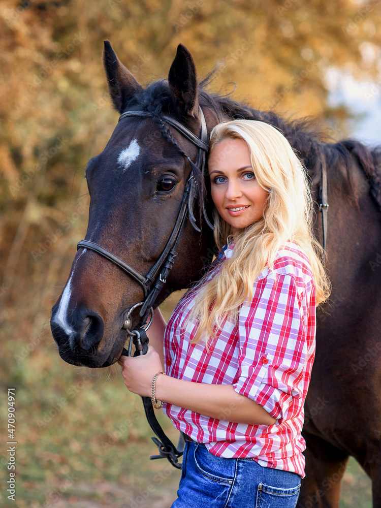Fototapeta premium beautiful caucasian girl with a horse in the forest at sunset