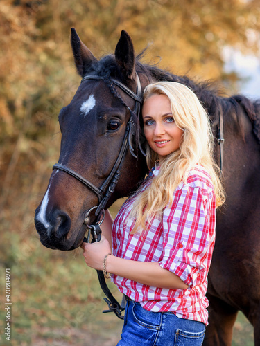 beautiful caucasian girl with a horse in the forest at sunset © Виктория Дубровская