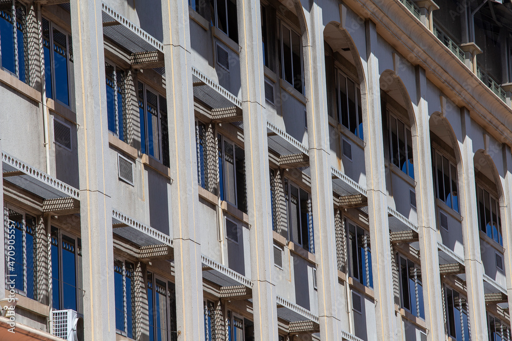 Stone wall of a building with windows on a background Stone wall of a building with windows on a background